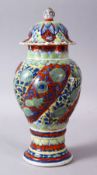 A 19TH / 20TH CENTURY CHINESE KANGXI STYLE PORCELAIN RIBBED VASE AND COVER, With underglaze blue