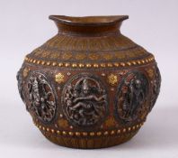 AN INDIAN COPPER BULBOUS SHAPED VASE, the body onlaid with silver panels of Indian gods, within
