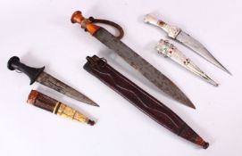 THREE ISLAMIC DAGGERS, longest 46cm.