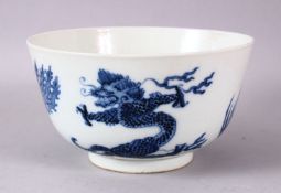 A CHINESE BLUE AND WHITE PORCELAIN BOWL, painted with phoenix and dragons, the base with Kangxi