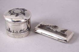 AN IRAQI SILVER AND NIELLO CIRCULAR BOX AND COVER, together with a similar small hinged box, 5.5cm