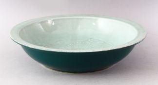 A 20TH CENTURY CHINESE CELEDON CIRCULAR DISH, the centre with moulded dragon decoration, green