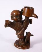 A JAPANESE BRONZE FIGURE OF A BOY & PIG, the boy holding an oil vessel aloft, signed underside,