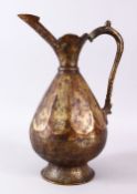 A SELJUK STYLE BRONZE EWER, with panels of engraved calligraphy, 35cm high.