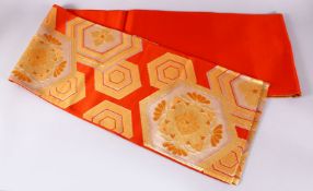 A FINE JAPANESE SILK EMBROIDERED FUKURO OBI TIE - upon an orange ground with silver and gold