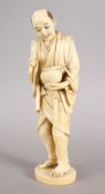 A GOOD JAPANESE MEIJI PERIOD CARVED IVORY OKIMONO - LANTERN LIGHTER, the man stod holding his