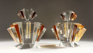 A GOOD PAIR OF LARGE AMBER TINTED ART DECO DESIGN SCENT BOTTLES AND STOPPERS..