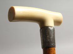 A VICTORIAN IVORY HANDLED WALKING STICK with engraved silver band. Birmingham 1896. Maker: J. H. 2ft