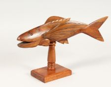 A PITCAIRN ISLAND CARVED WOOD FLYING FISH ON STAND, unsigned. 13ins long.