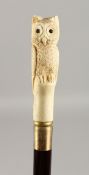 A CARVED BONE HANDLED WALKING CANE, 