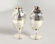 A PAIR OF SILVER PLATE CHICK EGG CUPS.