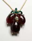 AN UNUSUAL GOLD, GARNET, DIAMOND AND ENAMEL DECORATED CLUSTER PENDANT AND CHAIN, in original box.