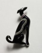 A SILVER DECO DESIGN BLACK ENAMEL DOG BROOCH.