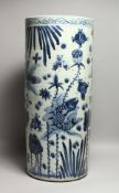 A CHINESE BLUE AND WHITE PORCELAIN UMBRELLA STAND decorated with fish. 24ins high.