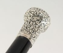 A GEORGE V SILVER TOP WALKING CANE, repousse with scrolls. London 1914. 2ft 11ins long.