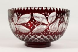 A LARGE BOHEMIAN RUBY TINTED CIRCULAR BOWL, engraved with pineapples and other fruit. 9.5ins