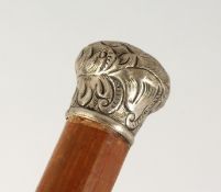 A WALKING CANE with silver handle. 2ft 10ins long.