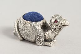 A SILVER PLATE CAMEL PIN CUSHION.