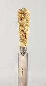 A GOOD JAPANESE MEIJI-PERIOD IVORY AND SILVER PAGE TURNER, the handle carved with rats and fruit.