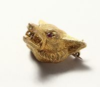 A 9CT GOLD FOX HEAD BROOCH with ruby eyes. 10.8cts.