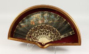 A GOOD 18TH CENTURY FRENCH IVORY AND PAPER FAN in a glass case, with figures dancing in a garden
