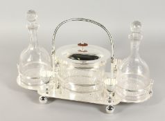 A GOOD SILVER PLATE OVAL GLASS BOX AND PAIR OF DECANTERS with four egg cups on a stand.