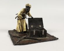 A GOOD AUSTRIAN PAINTED COLD CAST GROUP, an Arab opening a box of swords on a carpet. 5ins.