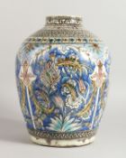 A LARGE QAJAR POTTERY VASE blue ground decorated with four large panels of flowers with bells. 15ins
