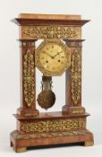 A GOOD 19TH CENTURY FRENCH EMPIRE WALNUT AND ORMOLU PILLAR CLOCK with swing pendulum. 20ins high.