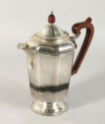 AN OCTAGONAL COFFEE POT with wooden handle. Birmingham 1935. Weight: 20ozs.