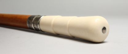 A VICTORIAN TURNED IVORY HANDLED WALKING STICK with engraved silver band. Birmingham 1897. 2ft 10ins