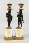 A SUPERB PAIR OF REGENCY BRONZE, ORMOLU AND MARBLE CUPIDS, formed as standing bronze cupids