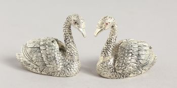 A PAIR OF .925 SILVER PLATE SWANS SALT AND PEPPERS. 1.5ins high.