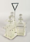 A CHRISTOPHER DRESSER DESIGN SILVER PLATE THREE BOTTLE CRUET.