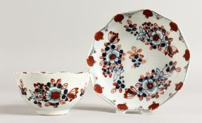 A RARE 18TH CENTURY LIVERPOOL TEA BOWL AND SAUCER painted in Imari style with moulded rim.