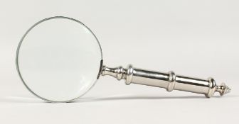 A MAGNIFYING GLASS with chrome handle.