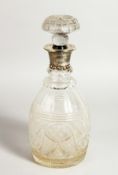 A CUT GLASS DECANTER AND STOPPER with silver band. Sheffield 1928.