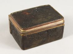 AN 18TH CENTURY TORTOISESHELL BOX AND COVER with musical trophies in relief. 3ins.