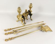 A GOOD SET OF THREE BRASS FIRE IRONS AND DOGS.