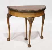 A GEORGIAN STYLE WALNUT HALF MOON CARD TABLE, with green baize, on cabriole legs ending in claw