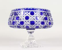 A CUT BLUE CRYSTAL BOHEMIAN CIRCULAR BOWL on square stand. 8ins diameter.