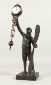 A BRONZED AIRMAN MYSTERY CLOCK holding a propeller, on a square base. 15ins high.