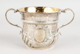 A VICTORIAN TWO-HANDLED SILVER PORRINGER, wrythen fluted base. 4.25ins diameter. London 1884. Maker: