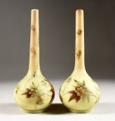 A SMALL PAIR OF BURMESE BULBOUS VASES painted with flowers. 7.5ins high.