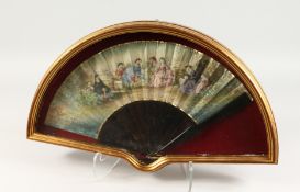 A GOOD 18TH CENTURY FRENCH TORTOISESHELL AND PAPER FAN in a glass case, ladies and children in a