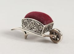 A SILVER WHEELBARROW PIN CUSHION.