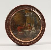 A 19TH CENTURY TORTOISESHELL CIRCULAR BOX, the lid painted with a tavern scene. 3ins diameter.