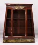 A RARE EGYPTIAN REVIVAL PAINTED OPEN FRONTED BOOKCASE of tapering form, the top with applied