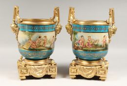 A PAIR OF SEVRES STYLE AND GILT BRONZE CACHE POTS painted with cherubs. 14ins high.