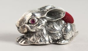 A SILVER RABBIT PIN CUSHION.